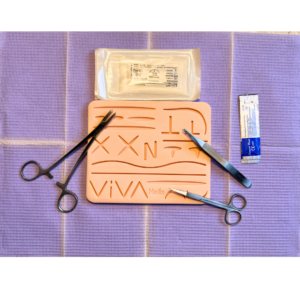 VivaMedix suturing kit suture pad and tools laid out